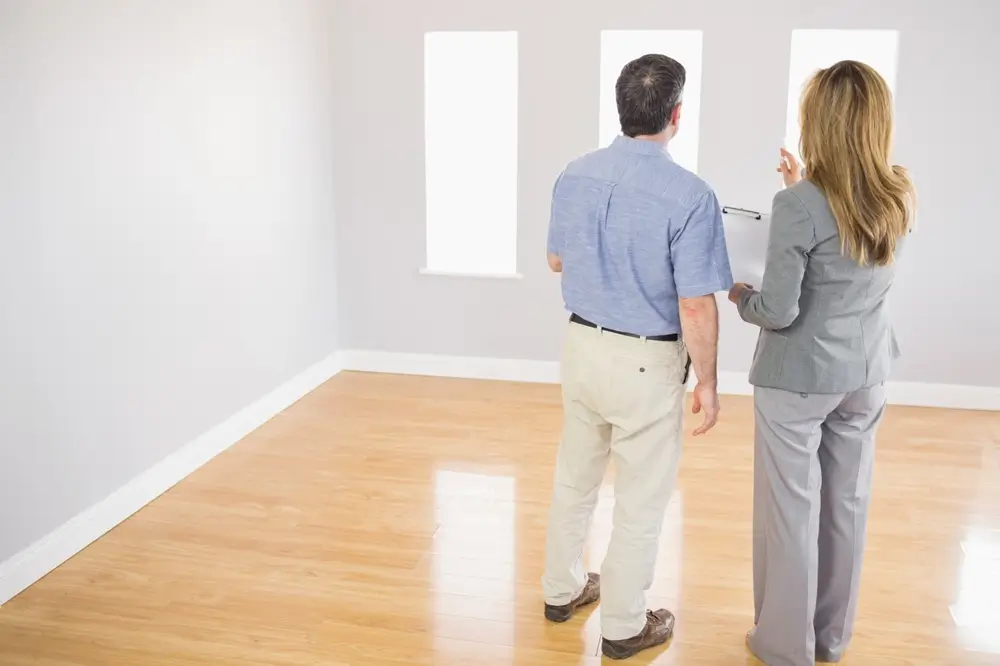 Couple reviewing a finished, freshly painted room