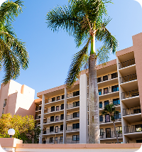 Palm trees in front of a freshly painted HOA community building