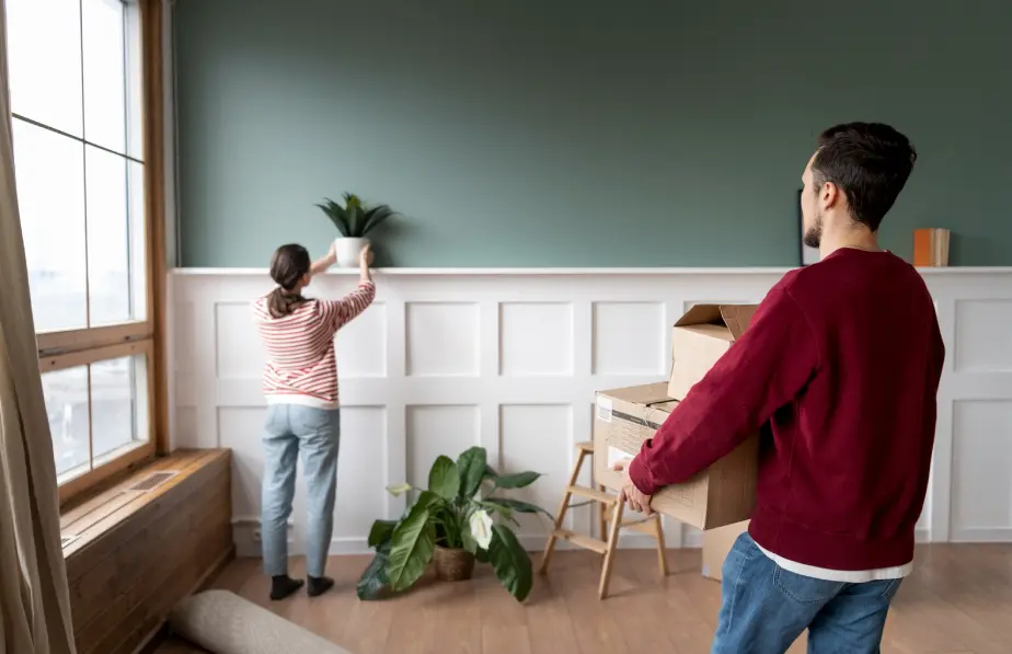 Painter preparing an interior wall of an occupied unit