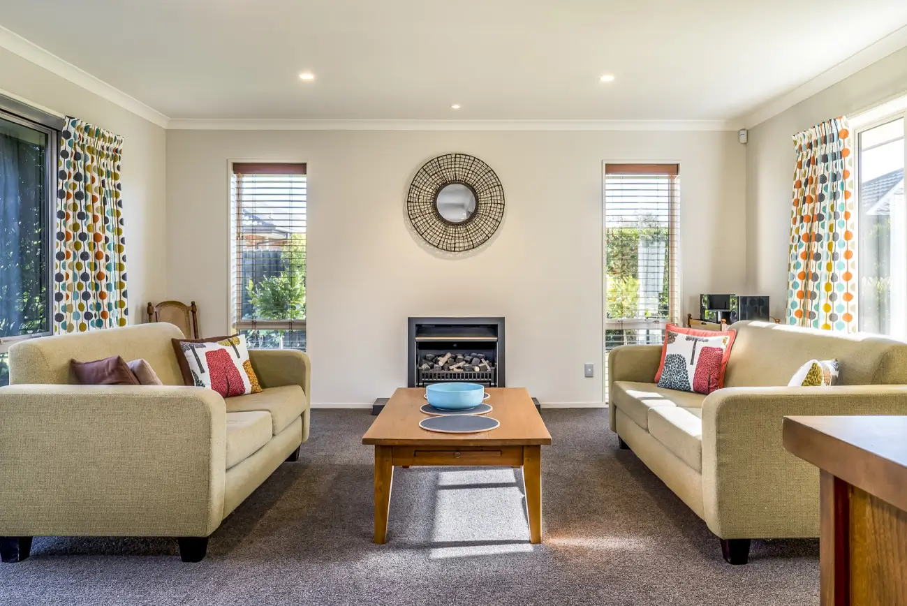 Bright living room with freshly painted walls and neutral furnishings