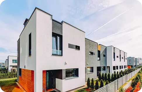 Modern white multi-unit residential building with fresh exterior paint