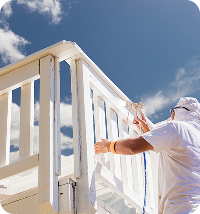 Close-up of touch-up painting on a weathered exterior surface