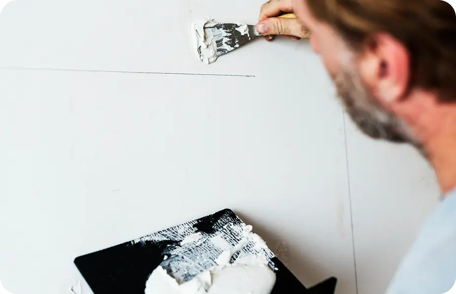 Painter performing targeted touch-up work on an exterior wall